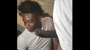 A black slave wearing a collar gets facialized in a gay porn video